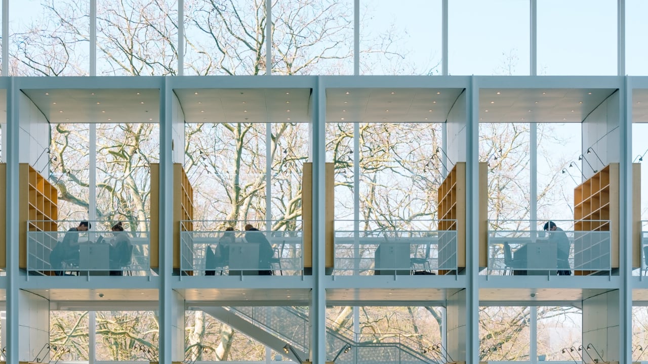 Photo of a multi-floored library with study rooms